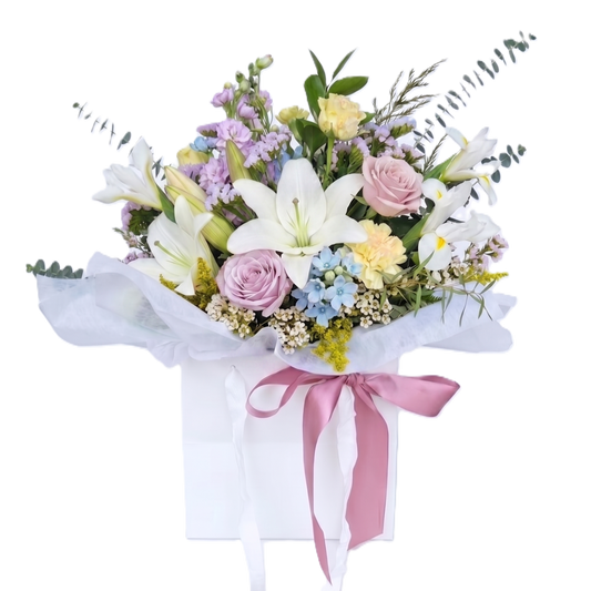 Top quality premium pastel flowers arranged with fresh foliage in a wrapped bouquet