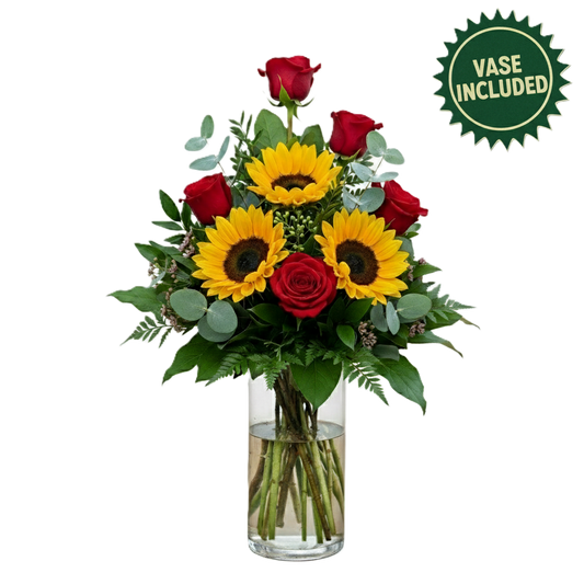 Majestic regal blossom arrangement featuring red roses and sunflowers in a glass vase, hand-crafted for grand celebration delivery in South Auckland.