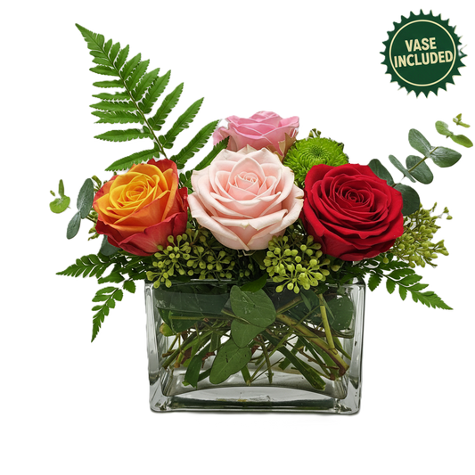 Vibrant mixed color rose arrangement in a glass cube vase hand-crafted for celebration and birthday delivery in South Auckland.
