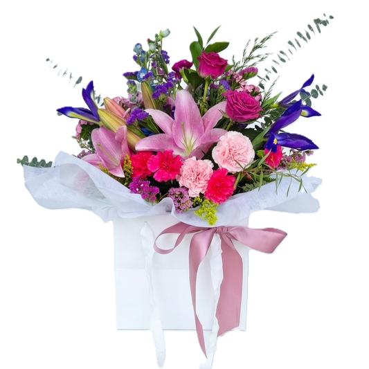 A vibrant wrapped bouquet of top quality premium bright flowers with fresh seasonal greenery